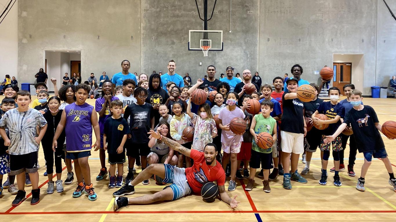 Children and coaches at a Sharks basketball clinic