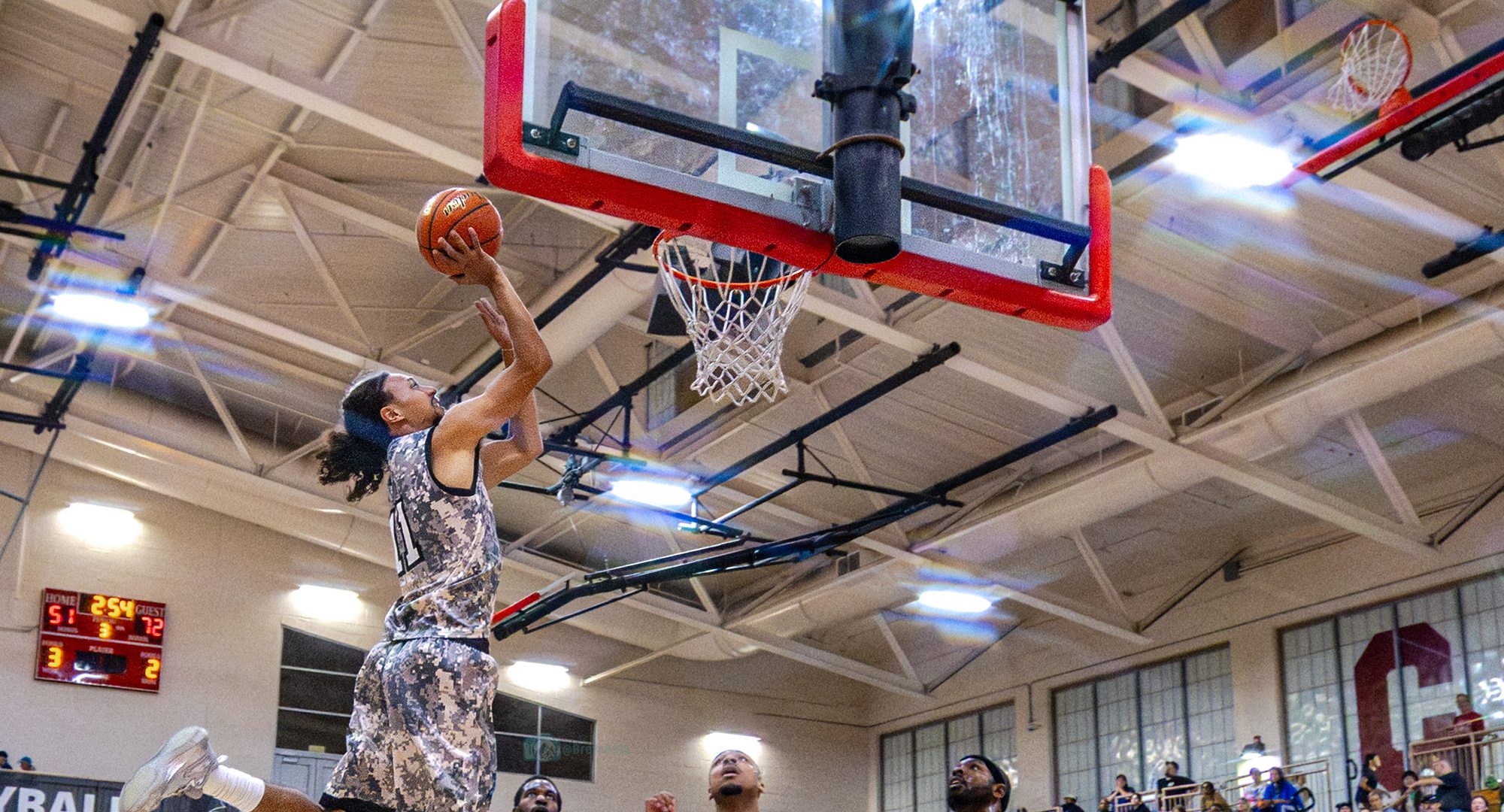 Sharks number 11 rising for a layup in front of a packed home crowd